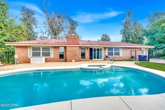 view of pool featuring an in ground hot tub