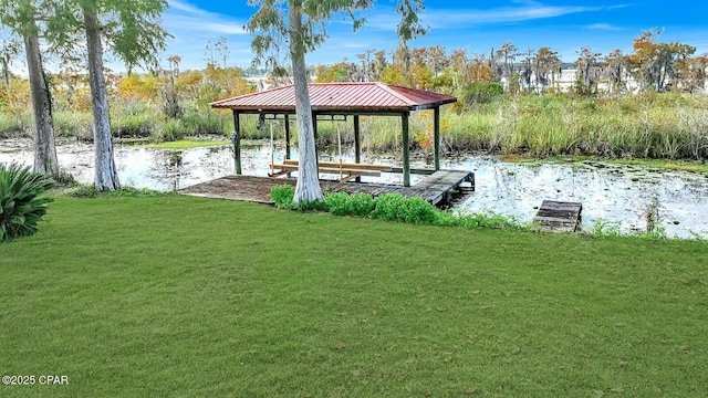 view of dock featuring a water view and a yard