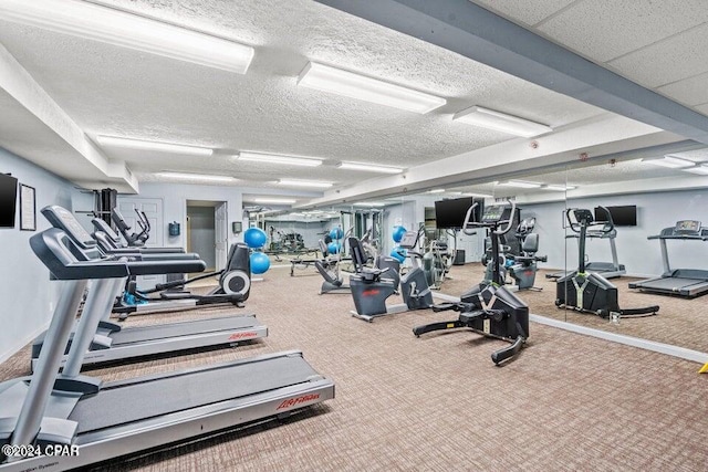 workout area with carpet flooring and a textured ceiling