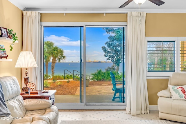 doorway to outside featuring a water view, ceiling fan, crown molding, and light tile patterned flooring