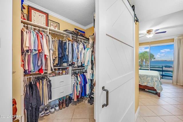 spacious closet featuring light tile patterned flooring and ceiling fan