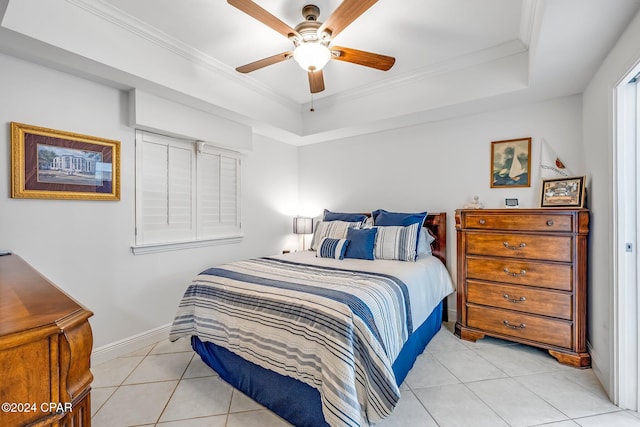 bedroom featuring light tile patterned flooring, ceiling fan, a raised ceiling, and crown molding