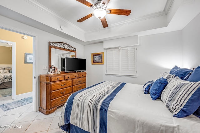 bedroom with ornamental molding, light tile patterned flooring, ceiling fan, and a raised ceiling