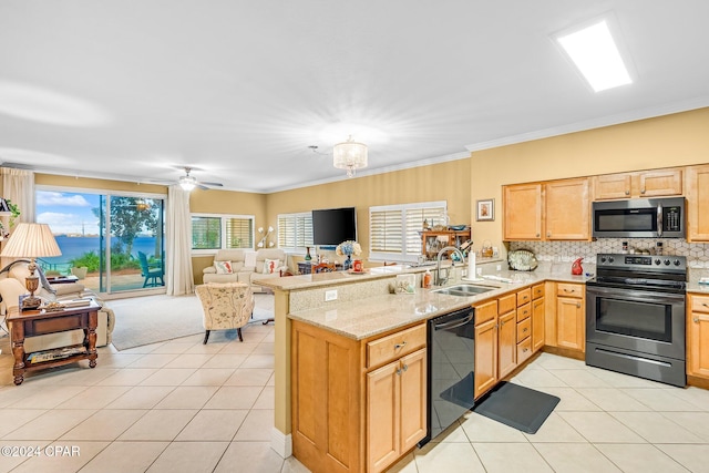 kitchen with stainless steel appliances, sink, light stone counters, kitchen peninsula, and crown molding