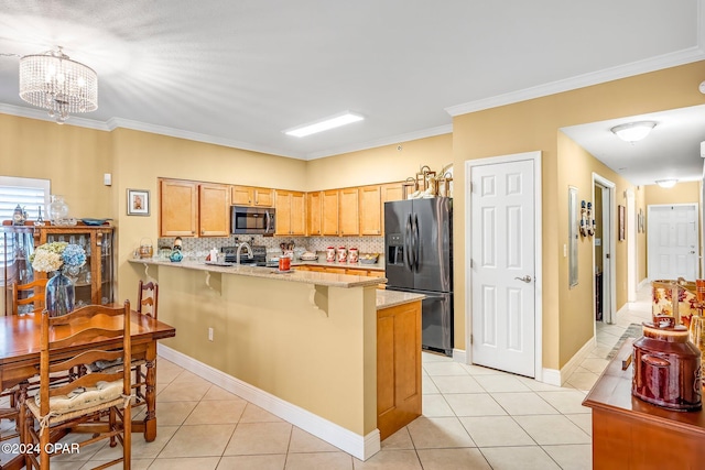 kitchen with light tile patterned flooring, appliances with stainless steel finishes, a breakfast bar area, backsplash, and crown molding