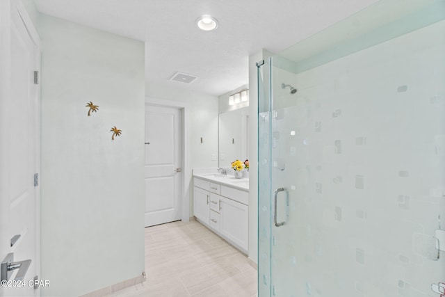 bathroom featuring vanity and a shower with shower door