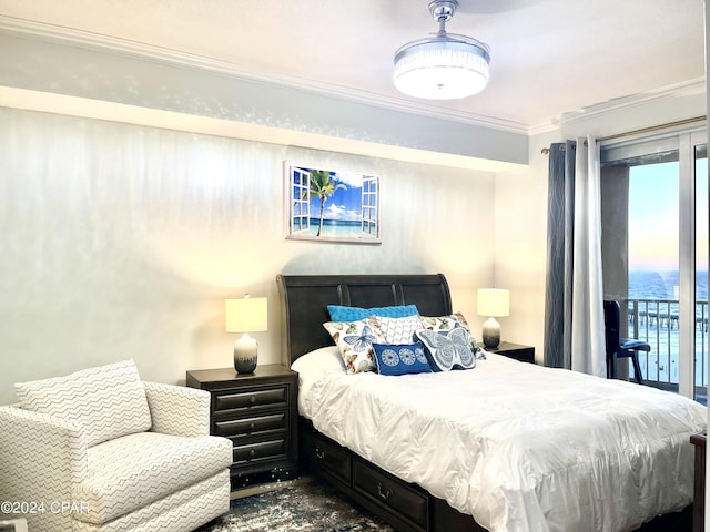 carpeted bedroom featuring access to outside, a water view, and ornamental molding