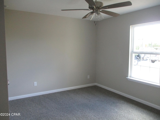 carpeted spare room with ceiling fan and plenty of natural light