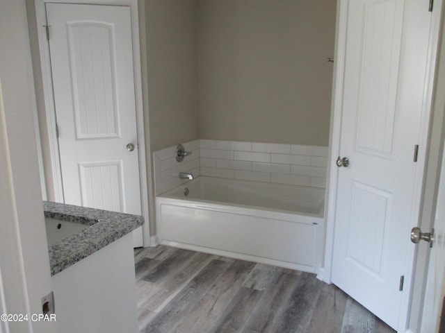 bathroom featuring a bathtub, vanity, and hardwood / wood-style flooring