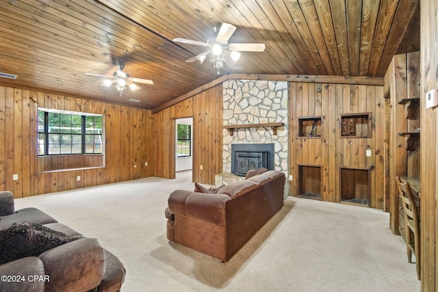 carpeted living room featuring ceiling fan, wood ceiling, and wooden walls