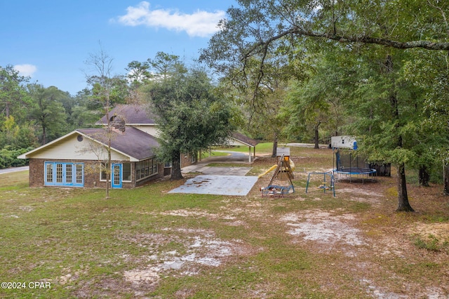 view of yard with a patio and a trampoline