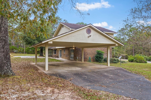 exterior space featuring a front yard and a carport