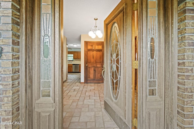 corridor with a chandelier