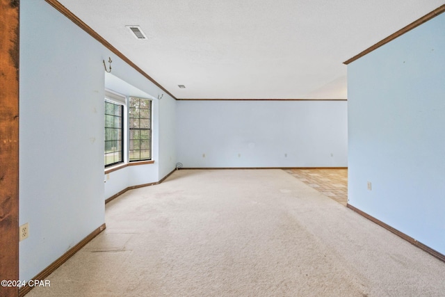 unfurnished room featuring light colored carpet and crown molding