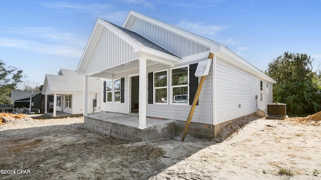 view of side of property featuring central AC unit and a patio area