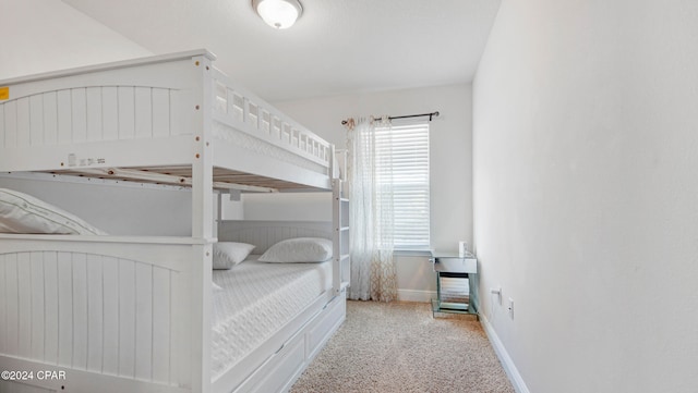 bedroom featuring light carpet