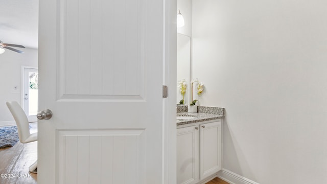 bathroom featuring hardwood / wood-style floors, vanity, and ceiling fan