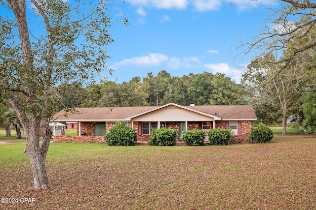 ranch-style home with a front lawn