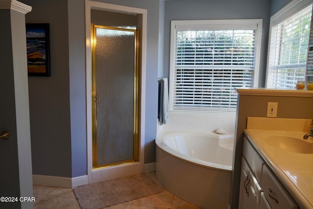 bathroom with tile patterned flooring, vanity, and separate shower and tub