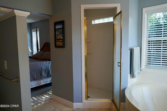 bathroom with tile patterned flooring and separate shower and tub