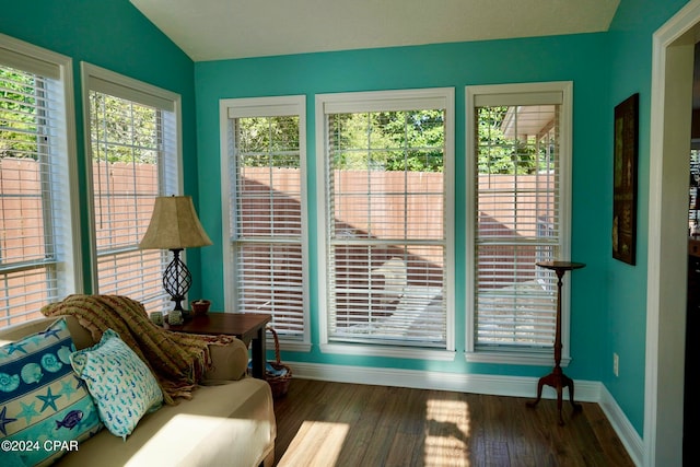 sunroom / solarium with lofted ceiling and a healthy amount of sunlight