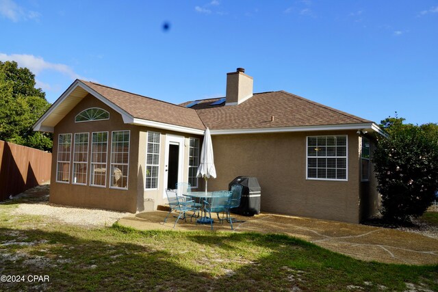 back of house with a patio