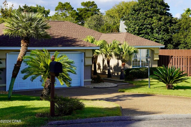 view of front of property with a garage and a front yard