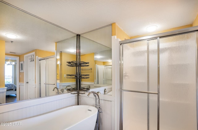 bathroom with plus walk in shower and a textured ceiling