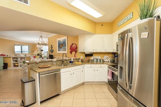 kitchen featuring stainless steel appliances, sink, light tile patterned floors, and white cabinets