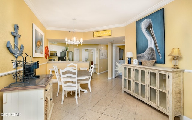 tiled dining area featuring ornamental molding and a chandelier