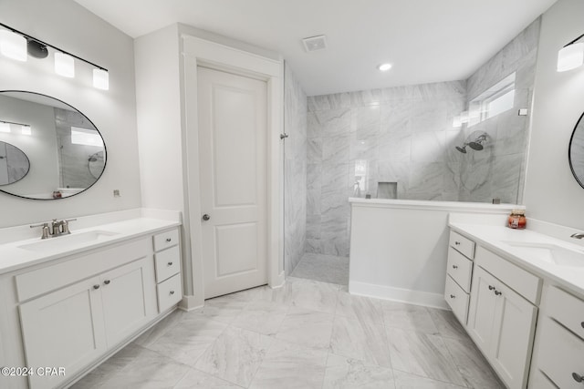 bathroom featuring vanity and a tile shower