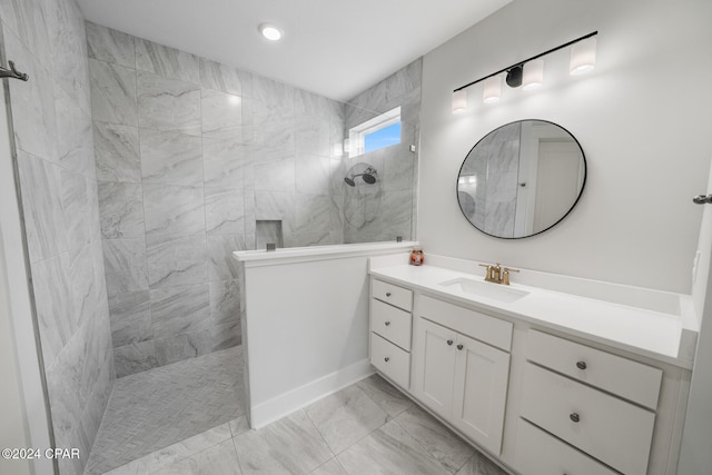 bathroom with vanity and tiled shower