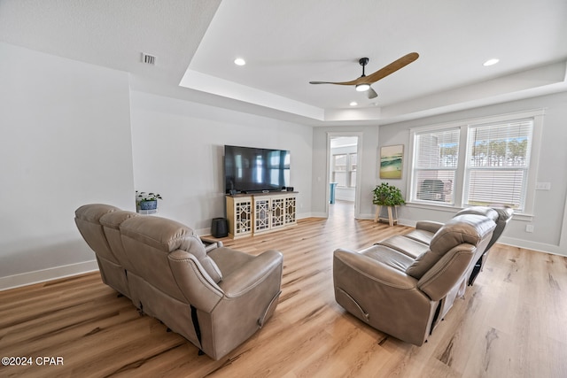 living room with ceiling fan and light hardwood / wood-style flooring