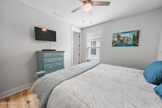bedroom with hardwood / wood-style flooring and ceiling fan