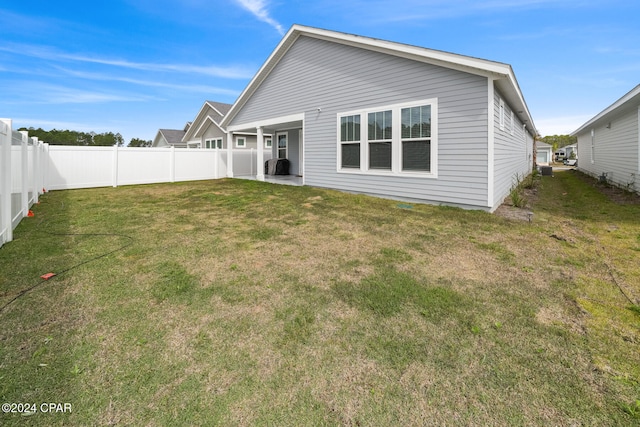rear view of house with a lawn