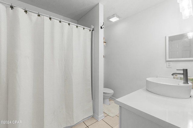 bathroom with tile patterned flooring, vanity, and toilet