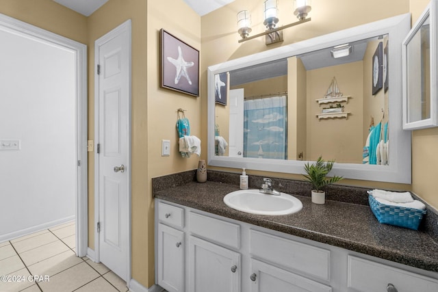 bathroom with tile patterned floors and vanity