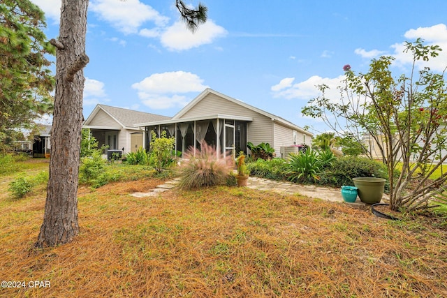 view of front of house featuring a sunroom