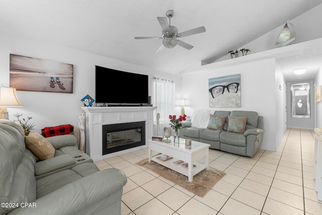 living room with ceiling fan, light tile patterned floors, and vaulted ceiling