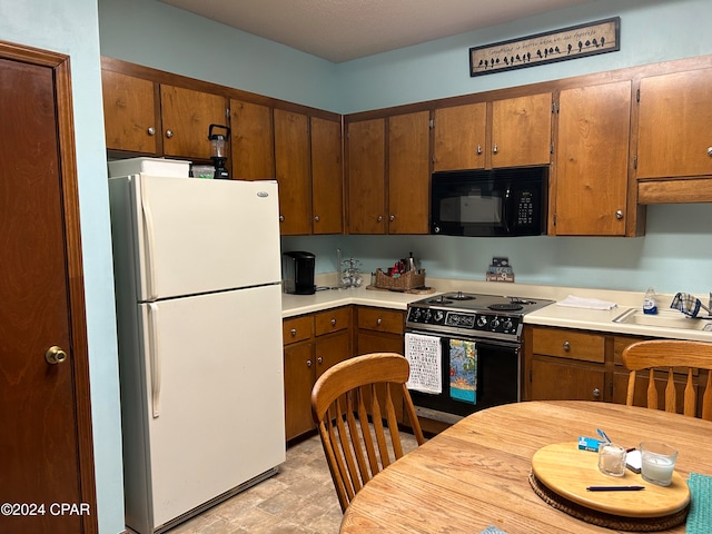 kitchen with sink and black appliances