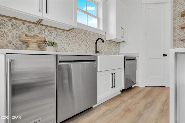 kitchen with tasteful backsplash, white cabinetry, and appliances with stainless steel finishes