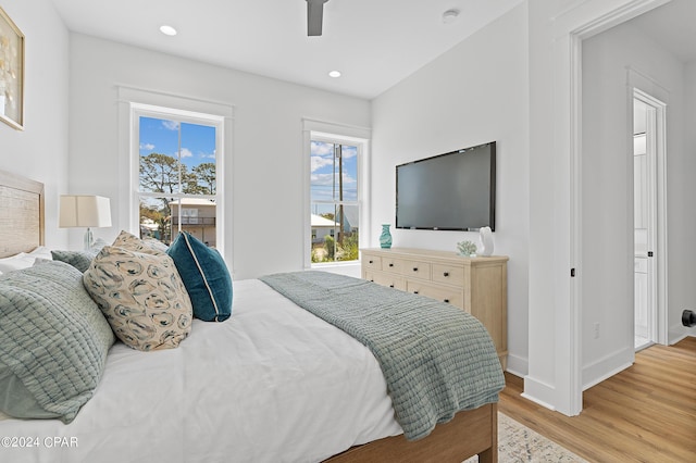 bedroom with ceiling fan and light hardwood / wood-style floors