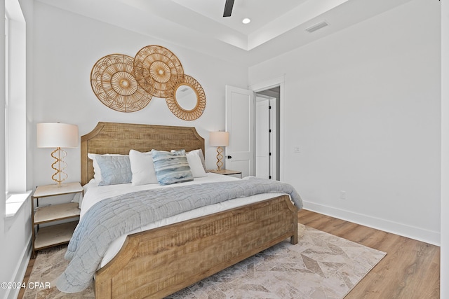 bedroom with ceiling fan and light wood-type flooring