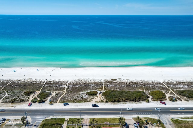 drone / aerial view with a beach view and a water view