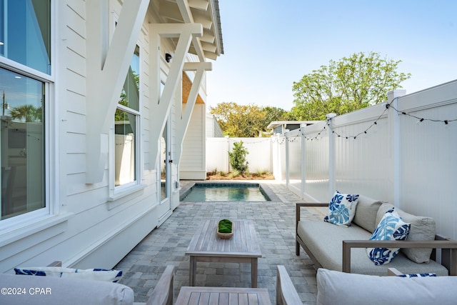 view of swimming pool featuring an outdoor living space and a patio area