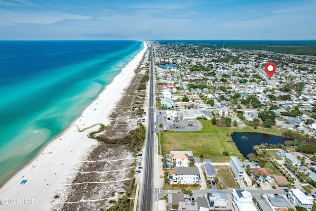 drone / aerial view featuring a water view and a beach view