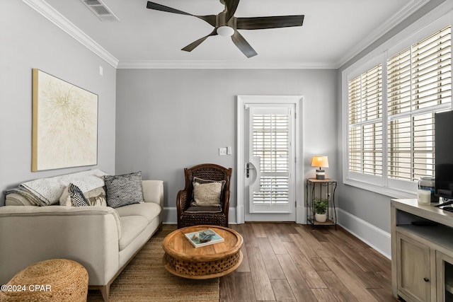 sitting room featuring crown molding, wood finished floors, ceiling fan, baseboards, and visible vents