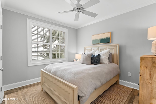 bedroom with wood finished floors, baseboards, ceiling fan, and crown molding