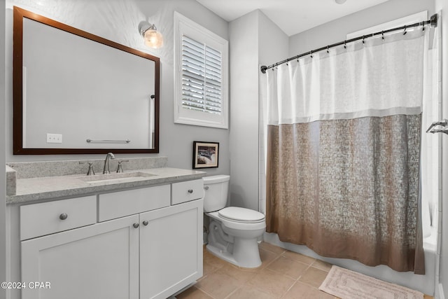 full bath featuring shower / tub combo, tile patterned floors, vanity, and toilet