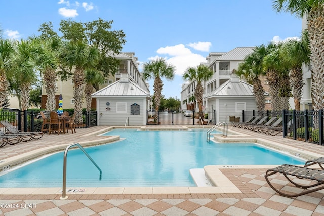 community pool featuring a patio and fence